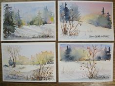 four watercolor paintings of trees and grass in the snow, on top of a wooden table