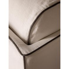 a close up view of the back end of a chair with a white fabric and black piping