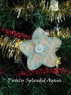 a star ornament hanging from a christmas tree