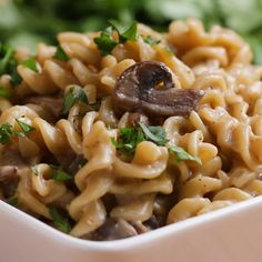 a white bowl filled with pasta and mushrooms