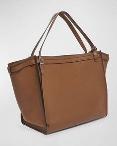 Coperni leather shoulder bag with fold-over flap accents.Adjustable buckle shoulder strap, 13' drop.Open top with hook closure.Interior, leashed zip pouch bag.Lining: Polyurethane.Approx. 13.8'H x 17.3'W x 9.8'D.Spot clean.Made in Italy Cognac Shoulder Bag With Palladium Hardware For Work, Office Satchel With Adjustable Strap And Calf Leather, Office Satchel With Adjustable Strap In Calf Leather, Office Leather Shoulder Bag With Palladium Hardware, Cognac Tote Shoulder Bag With Palladium Hardware, Zip Pouch, Pouch Bag, Free Bag, Travel Luggage