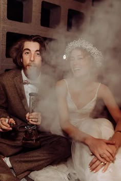 a man and woman sitting next to each other with steam coming out of their mouths