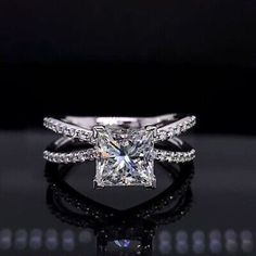 a princess cut diamond engagement ring with pave diamonds