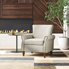 a living room with a chair and fireplace in the corner, next to a potted plant