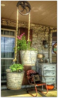 two hanging planters with plants in them on the porch