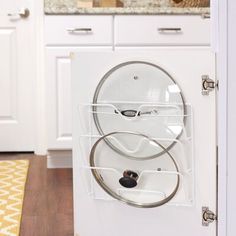 a white dishwasher sitting on top of a wooden floor next to a kitchen counter