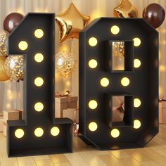 the letters b are lit up with lights and balloons