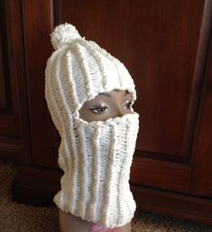 a mannequin's head wearing a white knitted hat