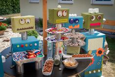 a table topped with lots of food and robot decorations