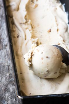 a scoop of ice cream in a black container