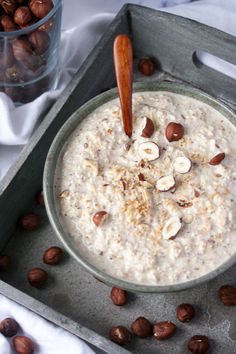 a bowl of oatmeal with nuts on the side