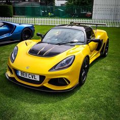 two yellow and blue sports cars parked in the grass