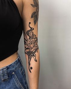 a woman's arm with a flower tattoo on the left side of her body