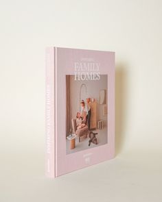 a pink book sitting on top of a white table