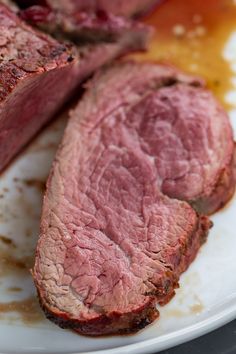 some meat is sitting on a white plate