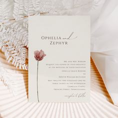 a wedding card with a flower on it