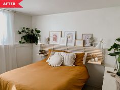 a bed room with a neatly made bed and plants