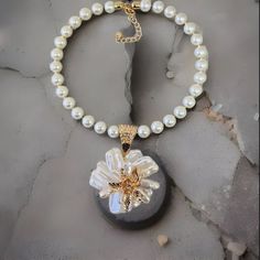 Length: 18.5" Round Glass Pearl Baroque Flower Shape Pendant Gold Tone Accents Large Gold-Tone Hook And Loop Clasp Lobster Claw Clasp With A 3" Chain Extender White Necklace With Flower Charm For Party, White Flower Charm Necklace, White Party Necklace With Flower Charm, White Flower Pendant Necklace For Parties, White Flower Necklace For Party, Elegant White Beaded Flower Necklace, White Flower-shaped Pearl Chain Necklaces, White Pearl Necklace With Flower Charm, White Pearl Flower Pendant Necklace