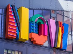 the word love spelled out in multicolored letters on top of an office building