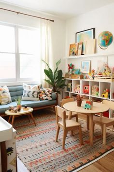 Shared Playroom And Family Room, Dark Green Playroom, Mid Century Modern Playroom, Play Nook In Living Room, Playroom Living Room, Playroom Theme Ideas, Playroom With Couch