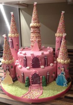 a pink castle cake with lots of sprinkles