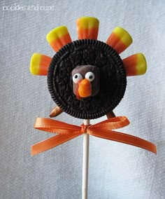 a cake shaped like a turkey on top of a stick