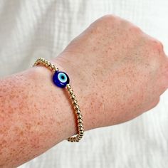 "Gold and blue jumbo evil eye mal de ojo bracelet Real gold filled beads and flat large glass evil eye  Bracelets are made to 7\" standard but can be customized to any length. Leave a note in the personalization box if you need a custom size" Hypoallergenic Evil Eye Bracelet With Round Beads For Gifts, Gold Evil Eye Bracelet With 8mm Beads As Gift, Hypoallergenic Evil Eye Bracelet With Round Beads, Gold Evil Eye Bracelet With 8mm Beads For Gifts, Adjustable Hypoallergenic Gold Evil Eye Bracelet, Cheap Gold Hand-strung Evil Eye Bracelet, Adjustable Black Hand-strung Evil Eye Bracelet, Gold-plated Evil Eye Bracelet With Adjustable Chain, Turkish Glass Evil Eye Bracelet Gold Metal