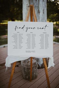 a wooden easel with a sign on it that says welcome to the couple and their guests