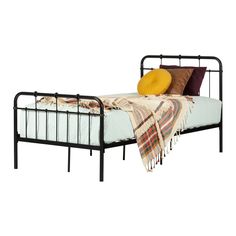 a metal bed frame with two pillows on it