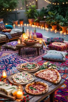 pizzas and candles on a colorful rug in the middle of an outdoor patio area