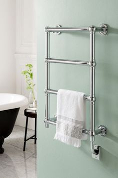 the towel rack is hanging on the wall next to the bathtub in the bathroom