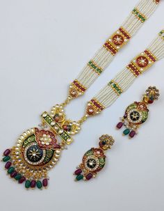 Most Gorgeous Indian Traditional Wedding Style Big Kundan Jewelry Set Reverse Meenakari Work This Long Ranihaar set is crafted with high-quality Kundan stones and stunning maroon-colored glass beads. Exude a Royal look with this Pleasing Monalisa beaded set on any occasion. Traditional White Bridal Sets For Ceremonial Occasions, White Kundan Sets For Celebrations, White Jewelry Sets With Mirror Work For Celebration, Traditional Multicolor Hand Set Bridal Sets, White Hand Set For Festivals, Multicolor Hand Set Festive Sets, White Traditional Wear With Stone Work For Festivals, Elegant Multicolor Traditional Wear For Celebration, Festive Multicolor Hand Set Sets