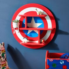 a captain america themed shelf in the corner of a child's room