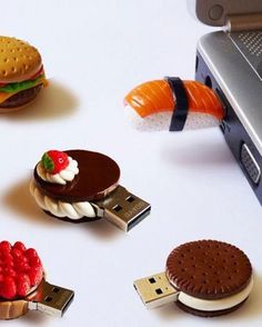 there are several different types of food on the table next to a laptop computer and cell phone