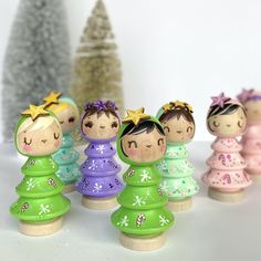 a group of small wooden dolls standing next to each other