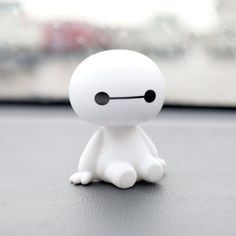 a small white toy sitting on top of a table