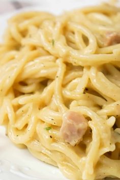 closeup of pasta with ham and cream sauce