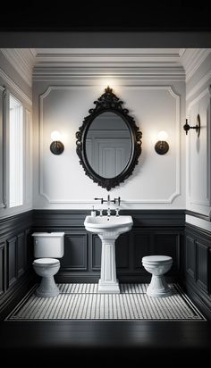 a white toilet sitting next to a sink in a bathroom under a large round mirror