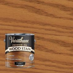 a can of wood stain sitting on top of a wooden floor