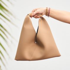 This clutch is your new best friend! Classy enough for a night on the town and casual enough for a day at the shops. It's the perfect size to fit all the essentials. 13.75" wide, 6" inch pouch with about an 8.5" handle drop. Versatile On-the-go Hobo Bag, On-the-go Laptop Sleeve Pouch Bag, Chic Clutch Pouch For On-the-go, Trendy Beige Top Handle Clutch, On-the-go Rectangular Soft Leather Clutch, Modern Tote Pouch For Shopping, Trendy Tote Pouch For On-the-go, Modern Tote-style Shopping Pouch, Trendy Beige Clutch For Shopping