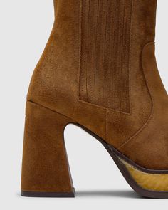 This style is true to size.

Bluebell ankle boots with geometric heel made from split leather. They feature a contrasting platform and elasticated side panels. They include an elasticated strap and a 10 cm suede heel. Side Panels, Suede Heels, Panel Siding, Ankle Boots, Heels, Boots, Leather