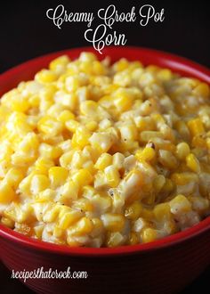 a red bowl filled with corn on the cob