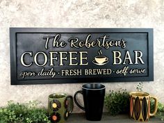 a sign that says the redefison's coffee bar and two mugs