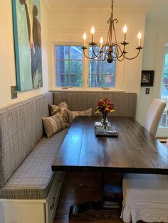 a wooden table sitting under a chandelier in a living room