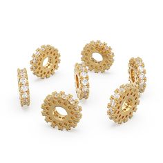 four pairs of gold and diamond earring sets, each with an open hole in the middle