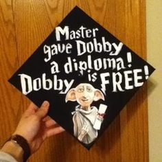 a black and white graduation cap with the words master gave dobby a diploma, dubby is free