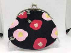 a black and pink purse with flowers on it