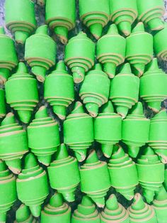 many green vases are stacked on top of each other