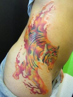 a person with a tattoo on their stomach that has a tiger painted on the side