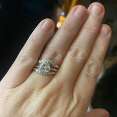 a woman's hand with two rings on it